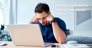 A person sitting at a desk looking worried or anxious while viewing a message on their laptop or phone.